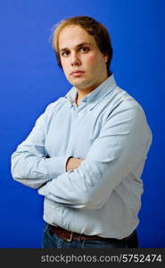 an young man portrait over a blue background