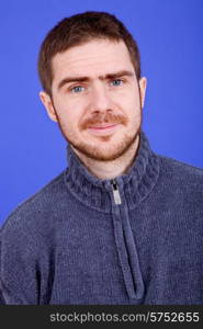 an young man portrait over a blue background