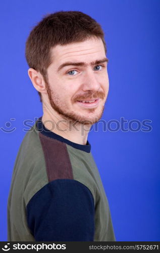 an young man portrait over a blue background