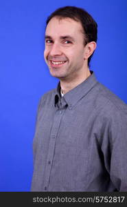 an young man portrait over a blue background