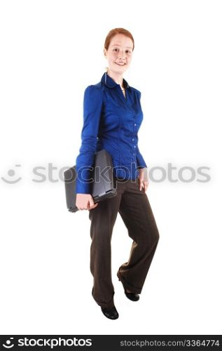 An young pretty red haired woman with a laptop under her arm,standing in the studio for white background.