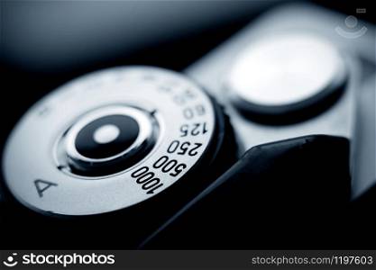 Analog film camera top view with a shutter dial set to aperture priority. Shutter speed dial.