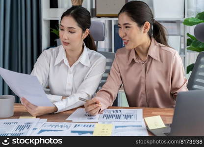 Analyst team colleagues discuss financial data on digital dashboard, analyzing charts and graph with supportive teamwork. Professional office use business intelligence to plan marketing. Enthusiastic. Analyst team colleague discuss financial data on digital dashboard. Enthusiastic