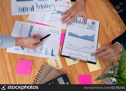 Analyst team in office analyzing financial data analysis for marketing strategy in workspace, pile of BI dashboard paper format with graph and chart to optimize performance and risk management. Entity. Analyst team in office analyzing financial data analysis papers. Entity