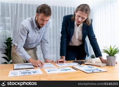 Analyst team in office analyzing financial data analysis for marketing strategy in workspace, pile of BI dashboard paper format with graph and chart to optimize performance and risk management. Entity. Analyst team in office analyzing financial data analysis papers. Entity