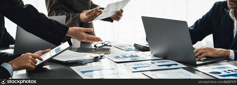 Analyst team working on BI Fintech to analyze financial dashboard paper at office workplace. Businesspeople reviewing report paper on table for business insight. Panorama shot. Prodigy. Analyst team analyzing business data paper on office table. Prodigy