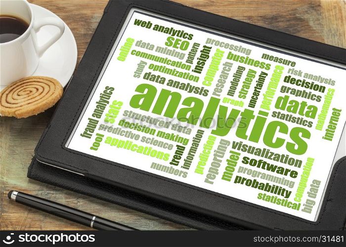 analytics and data analysis word cloud on a digital tablet with a cup of coffee
