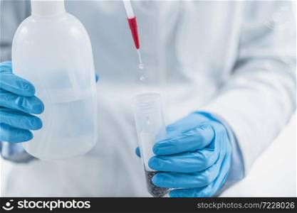 Analyzing Plant Samples for Presence of Pesticides in Farming Products. Pouring Water into Test Tube with Dissolved Samples in Laboratory. Analyzing Plant Samples for Presence of Pesticides in Farming Products