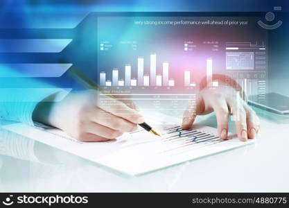 Analyzing statistics data. Close view of businesswoman working with papers at table