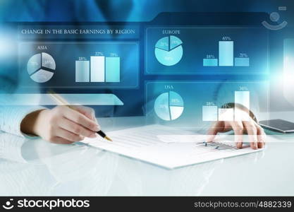 Analyzing statistics data. Close view of businesswoman working with papers at table