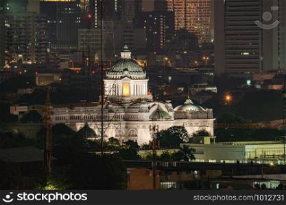 Ananta Samakhom Throne Hall and skyscraper buildings at night in urban city, Bangkok, Thailand. Royal king palace.