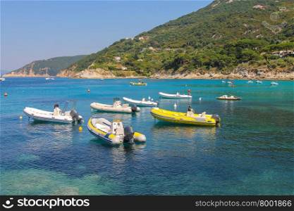 Anchored motorboats in waters of Tyrrhenian Sea, Sant Andreas on Elba Island, Italy