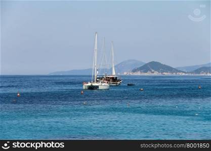Anchored sailboats in waters of Tyrrhenian Sea, Sant Andreas on Elba Island, Italy