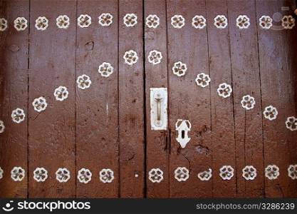 Anciend wood door with metal silver decoration rustic