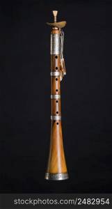 ancient asian woodwind musical instrument on a black background, surnay. national musical instrument of Asia