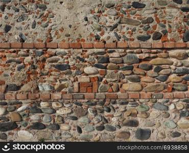 ancient brick wall background. ancient brick and stone wall useful as a background