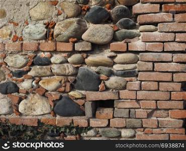 ancient brick wall background. ancient brick and stone wall useful as a background