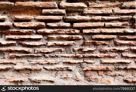Ancient bricks of Colosseum in Rome, may be used as background