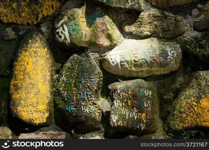 Ancient Buddhist prayer stones with written mantra