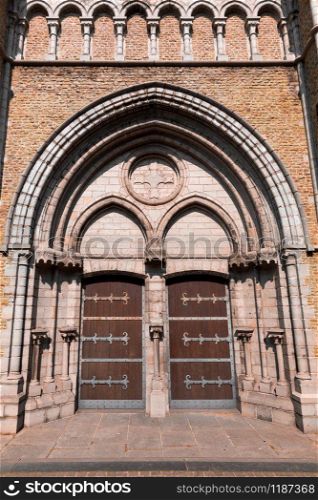 Ancient building facade with wooden doors, old provincial European town. Summer tourism and travels, famous europe landmark, popular places for vacation tour or holidays