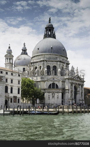 Ancient buildings and boats in the channel in Venice.