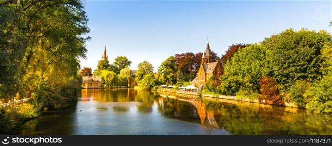 Ancient buildings in park with lake, old European town. Summer tourism and travels, famous europe landmark, popular places for tourists