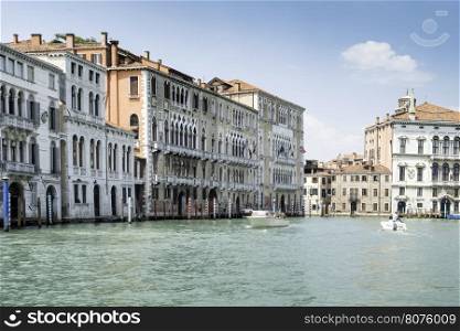 Ancient buildings in Venice. Boats moored in the channel. View from the side of the water