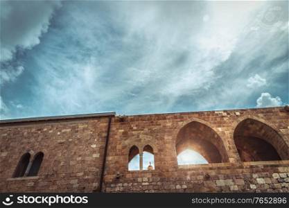 Ancient church in Lebanon, beautiful old fortress which window shows a cross, orthodox cathedral, house of God