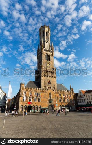 Ancient clock tower in provincial European town, bottom view. Summer tourism and travels, famous europe landmark, popular places for vacation tour or holidays