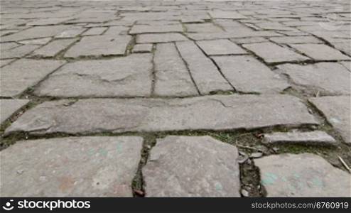 Ancient cobblestone pavement in old town dolly shot