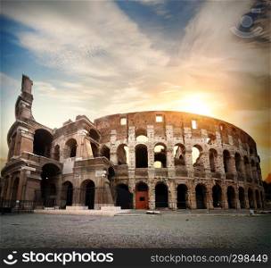 Ancient Colosseum and bright morning sun in Rome