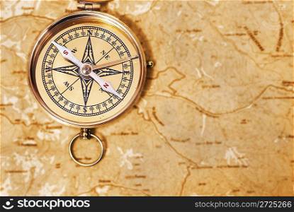 Ancient compass on the grunge old map