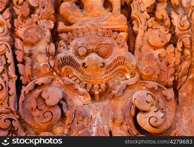 Ancient daemon carving on the wall in temple Banteay Srei, Cambodia