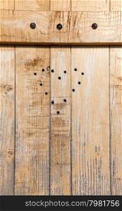 Ancient draw of heart on a door made of wood. Chalet in north Italy.