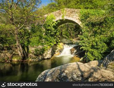 Ancient Genoese bridge, stream and cascade near Feliceto in the Balagne region of Corsica
