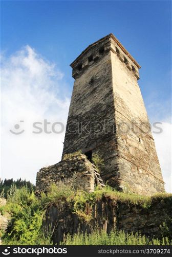 Ancient Georgian (Svanetian) tower on blue sky background