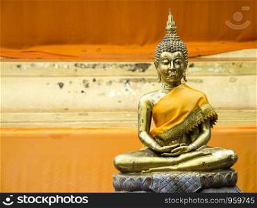 Ancient Golden Buddha in yellow robes