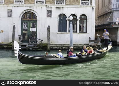Ancient gondolas boat in Venice. Gondolier on black gondola