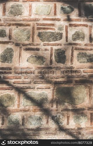 Ancient islamic wall on mosque. Bricks and stones.