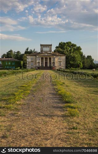 Ancient Italian Neoclassical House inside Park and Blue Sky with Clouds