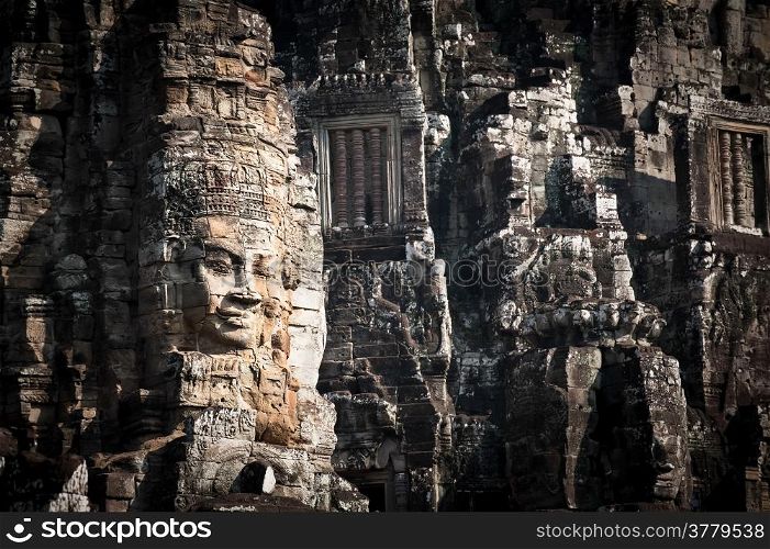 Ancient Khmer architecture. Huge carved Buddha faces of Bayon temple at Angkor Wat complex, Siem Reap, Cambodia
