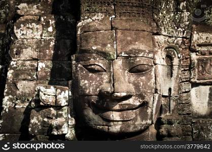 Ancient Khmer architecture. Huge carved Buddha faces of Bayon temple at Angkor Wat complex, Siem Reap, Cambodia