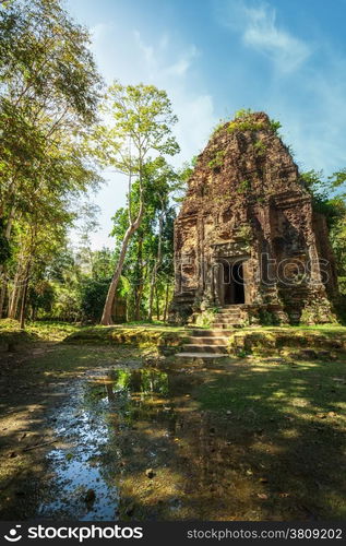 Ancient Khmer pre Angkor architecture. Sambor Prei Kuk temple ruins with giant banyan trees under blue sky. Kampong Thom, Cambodia travel destinations