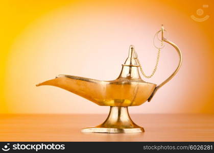 Ancient lamp against gradient background