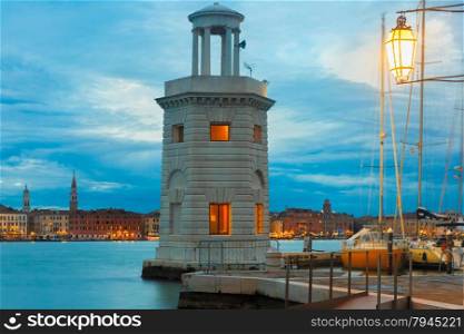 Ancient lighthouse on the island San Giorgio Maggiore at night in Venice lagoon, Italia