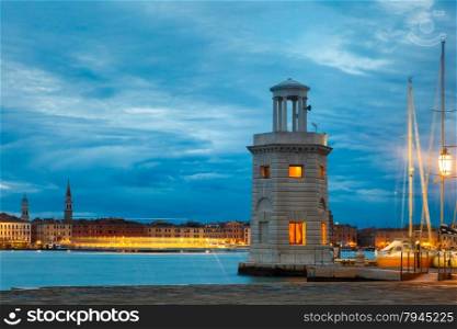 Ancient lighthouse on the island San Giorgio Maggiore at night in Venice lagoon, Italia