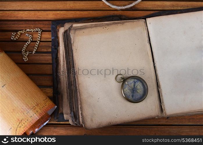ancient mariner&rsquo;s compass on old book