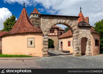 Ancient medieval city gates on a sunny day. Bavaria Germany. Rothenburg ob der Tauber.. Rothenburg ob der Tauber. Old stone medieval city gates.