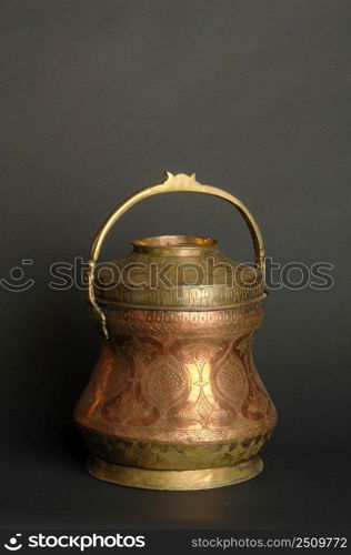 ancient metal bowl on dark background. antique bronze tableware. ancient metal utensils