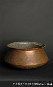 ancient metal bowl on dark background. antique bronze tableware. ancient metal utensils